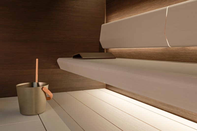 The atmosphere of the sauna is created by the harmony of benches, panels and lighting